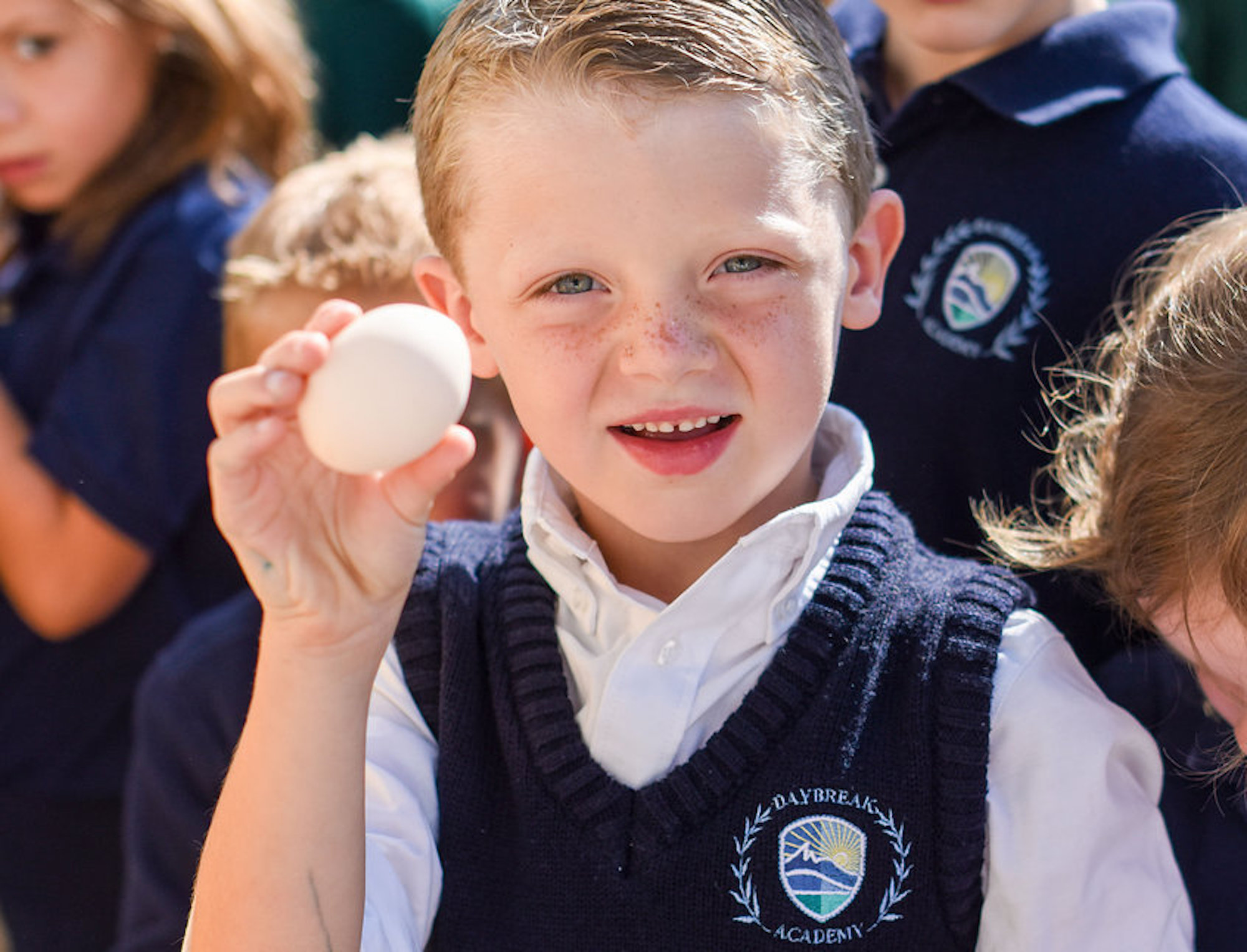 A boy holding a ball in his hand.